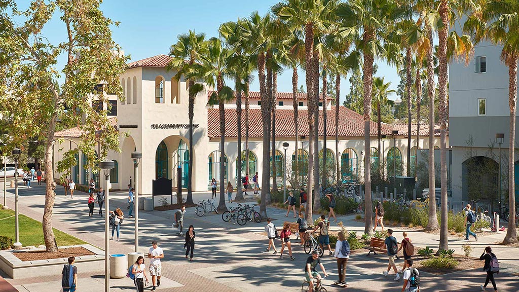 A group of people riding bikes in front of a building.