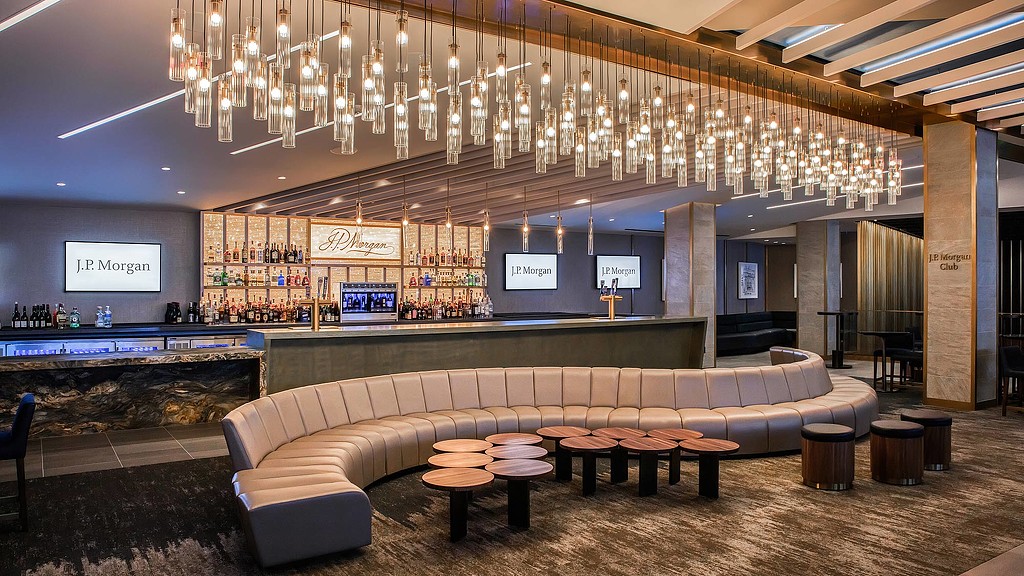 A room with a couch and tables.