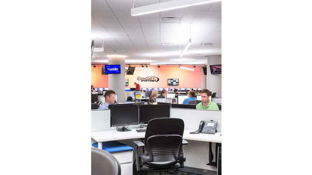A group of people sitting at computers.