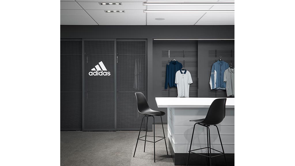 A room with a table chairs and a door with a white table.