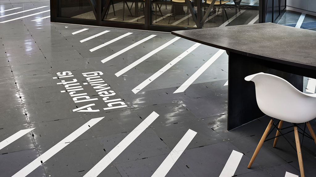 A table and chair on a tile floor.