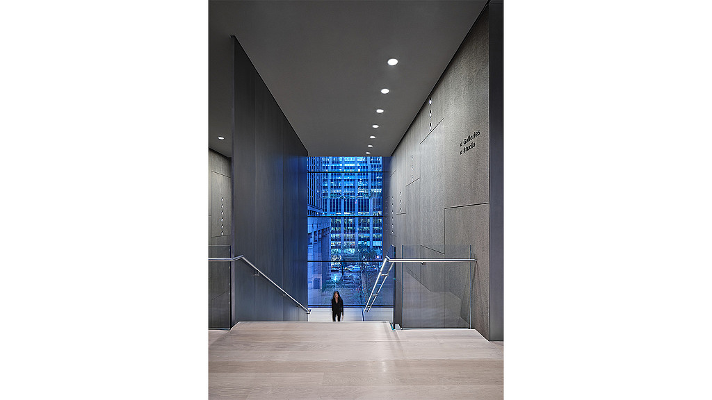 A person walking down a hall.