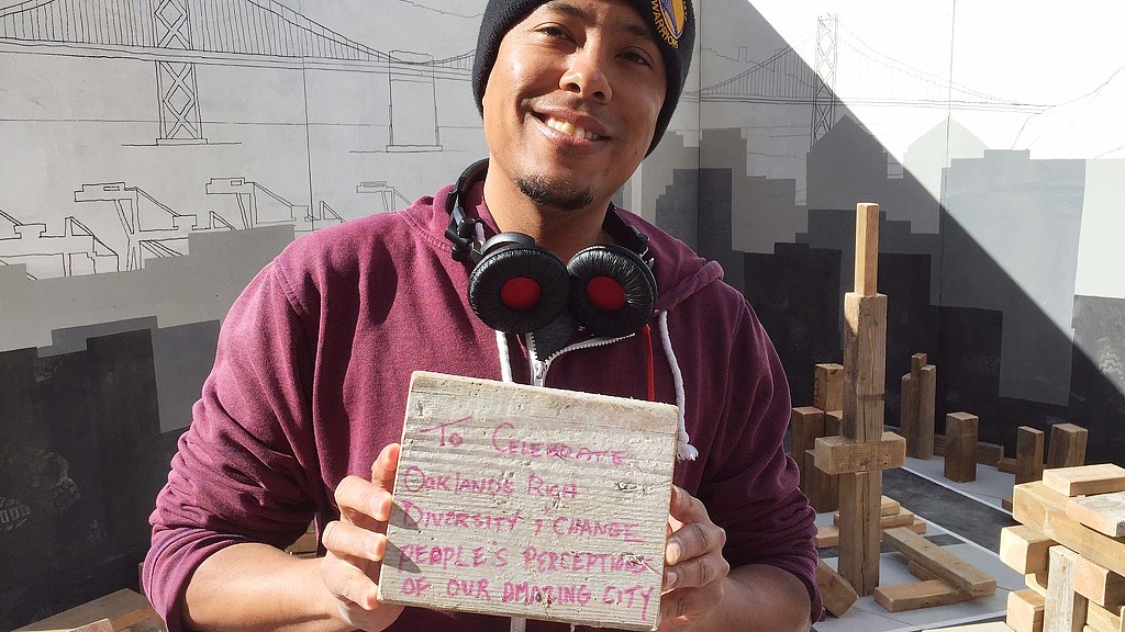 A man holding a sign and wearing headphones.