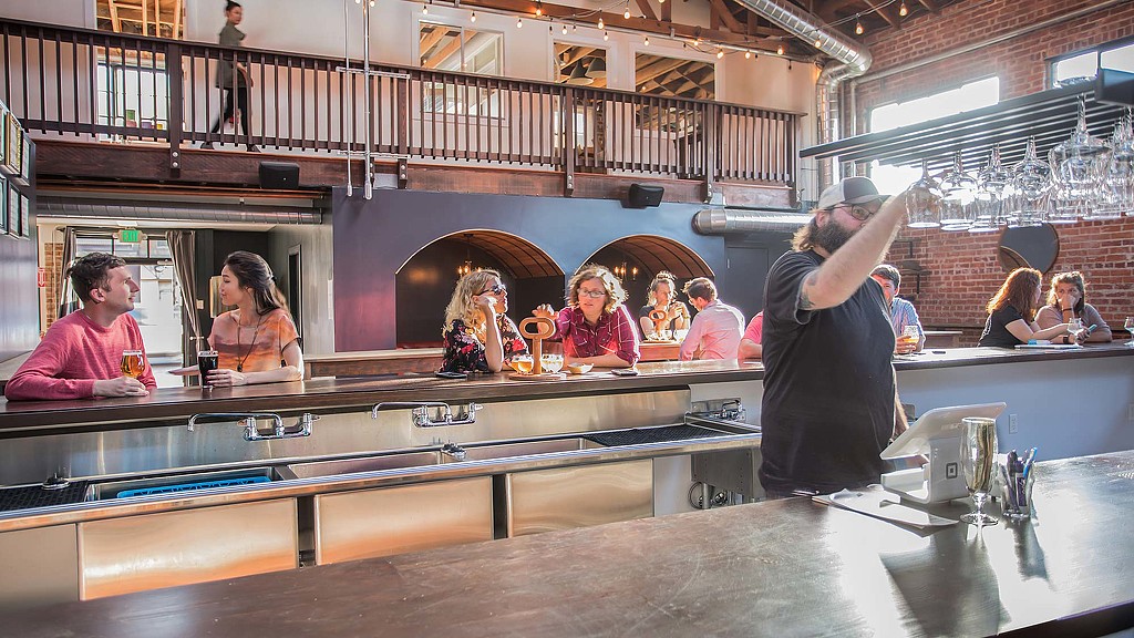 A group of people sitting at a bar.
