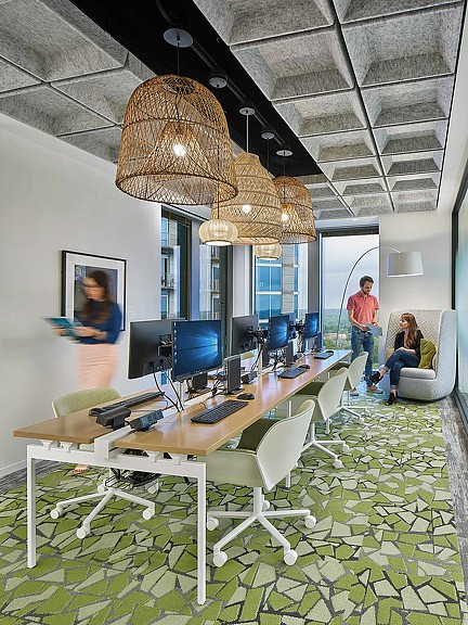 A room with a table and chairs and a chandelier.