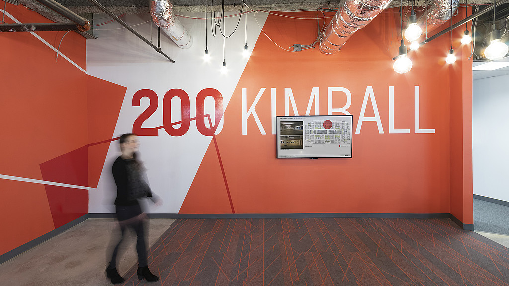 A person standing in front of a sign.