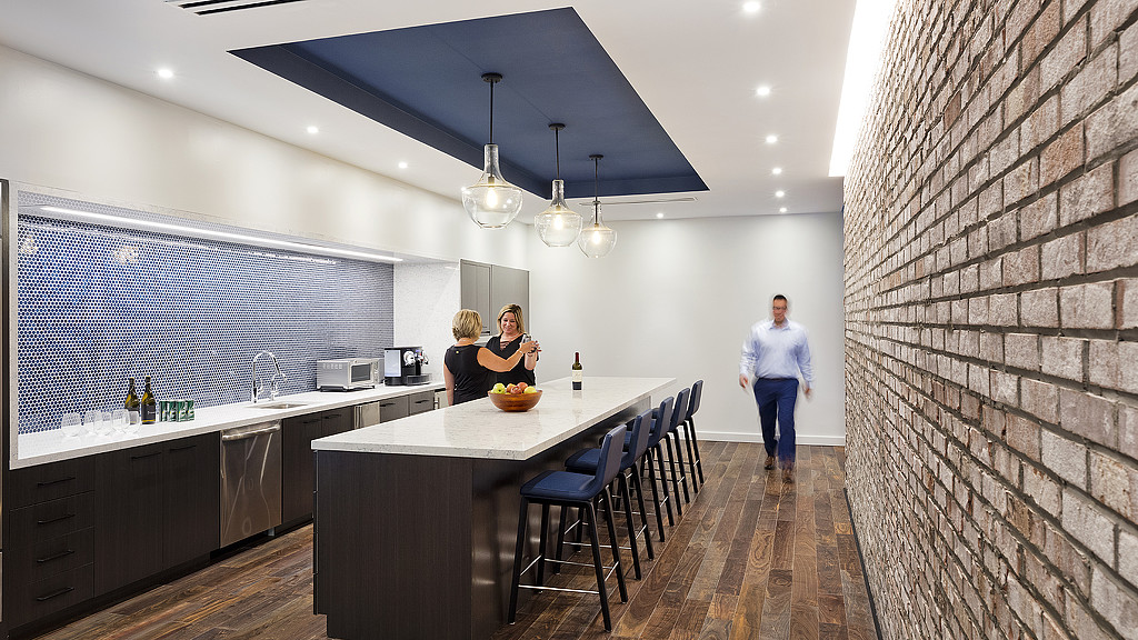 A couple of people in a kitchen.