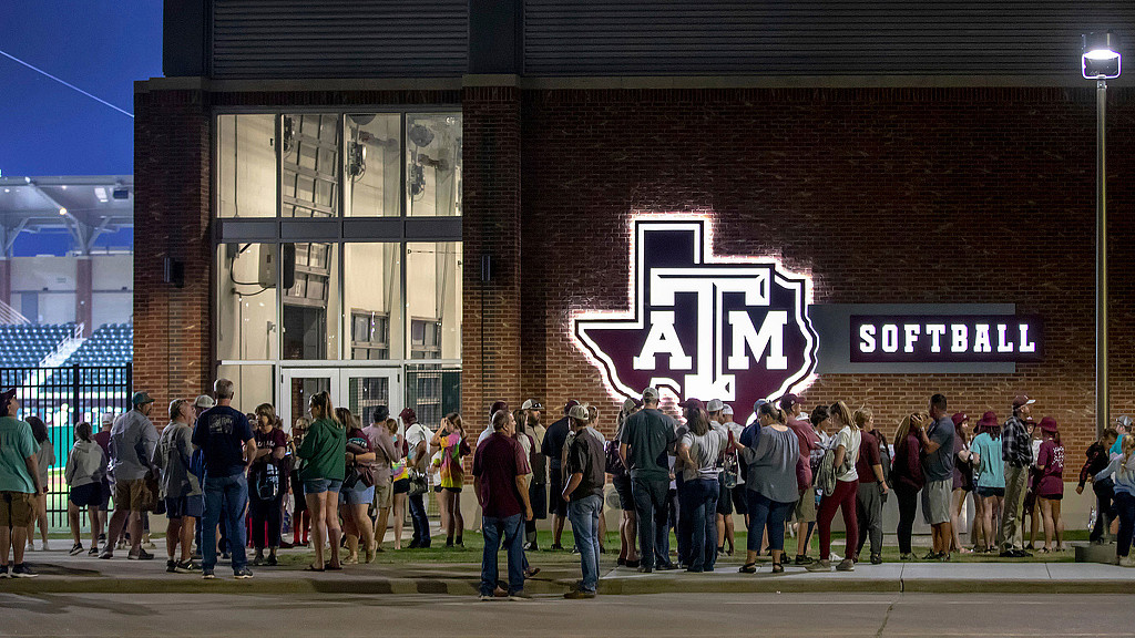 A group of people standing outside a building.