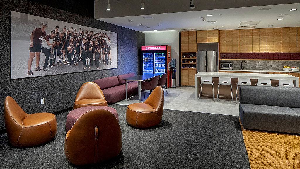 A room with chairs and a tv.