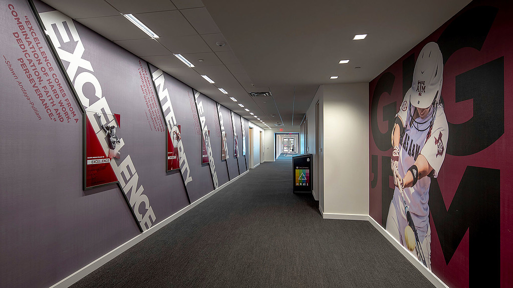 A long hallway with a wall of posters.