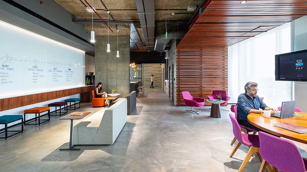 A person sitting at a table with a laptop.