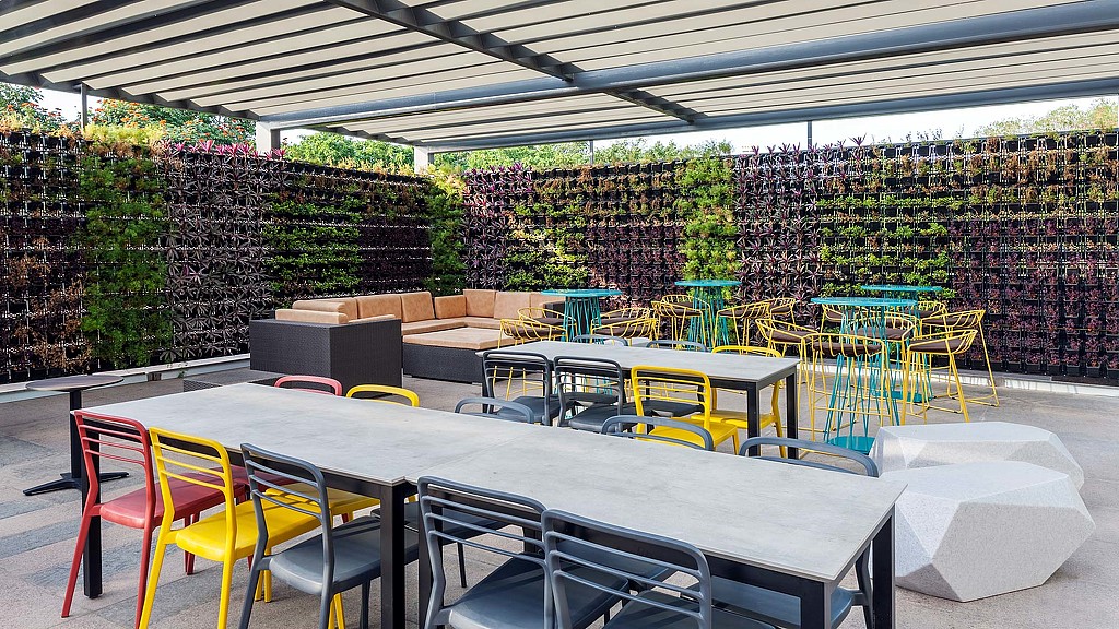 A group of tables and chairs outside.