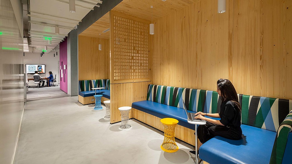 A person sitting on a couch using a laptop.