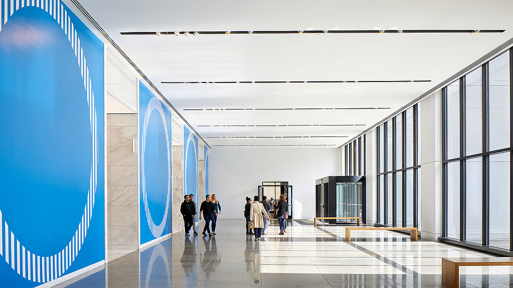 A group of people walking in a large building.