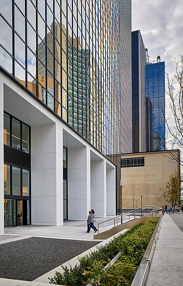 A person walking outside of a building.