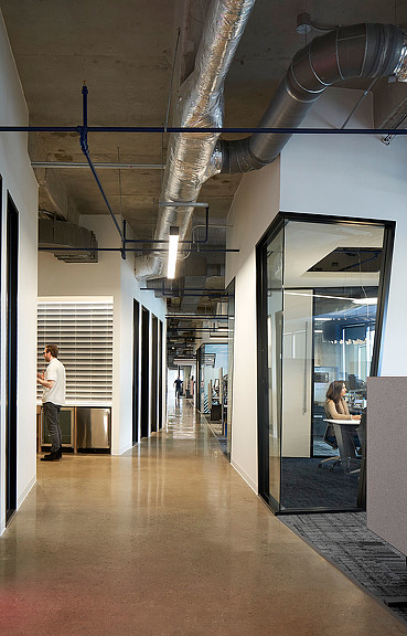 A man and woman in a hallway.
