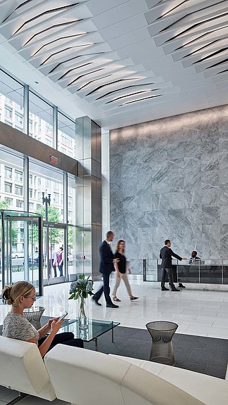 A group of people walking around a building.