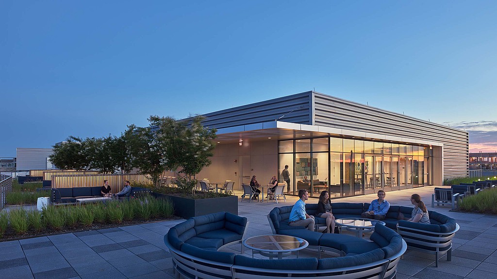 A group of people sitting outside a building.