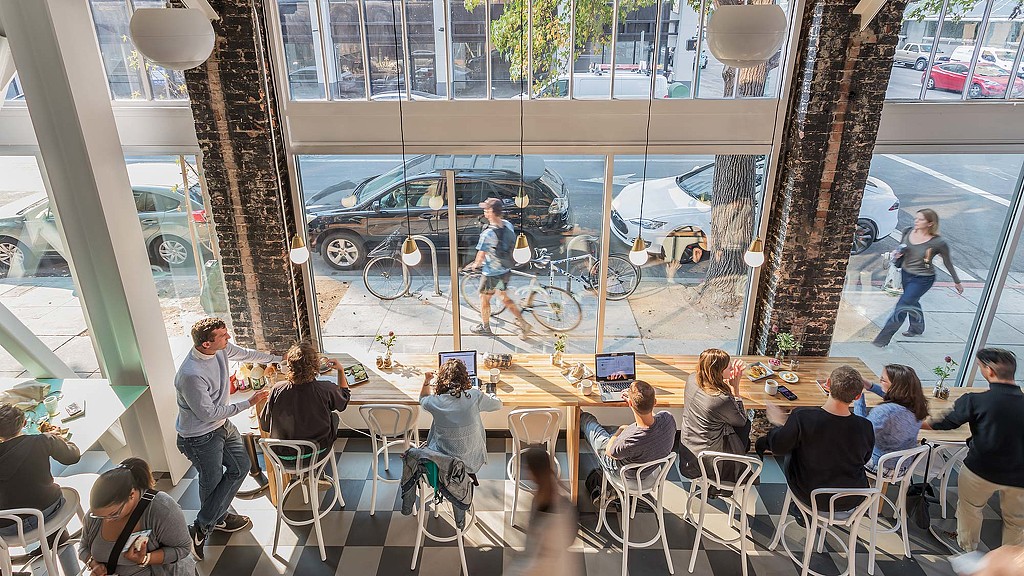 People sitting at tables in a restaurant.