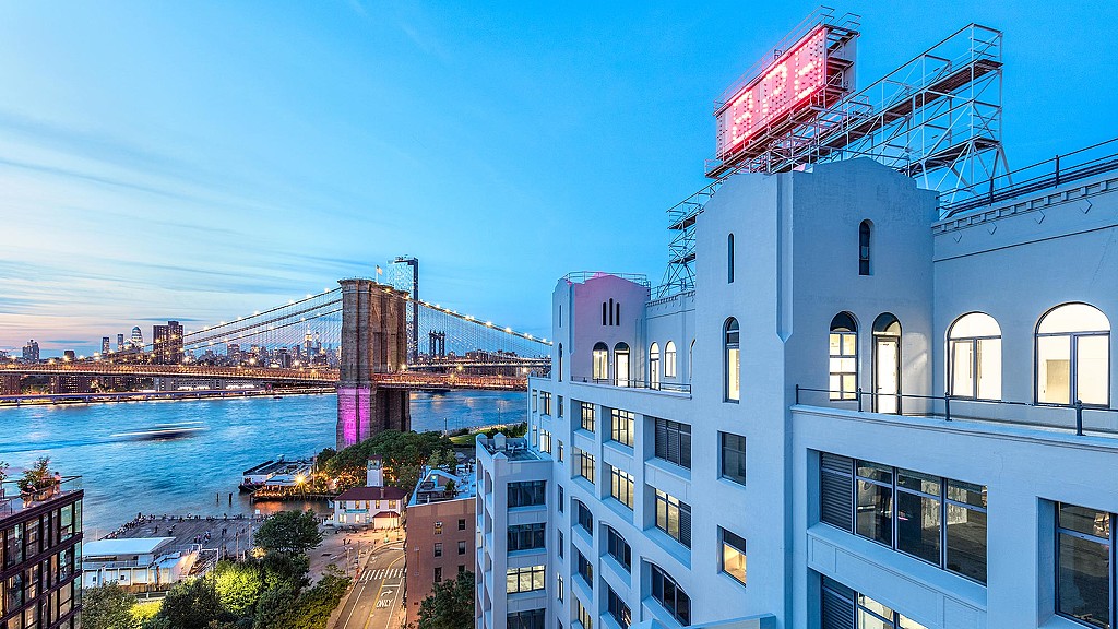 A building with a bridge in the background.