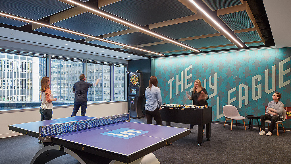 A group of people playing ping pong.