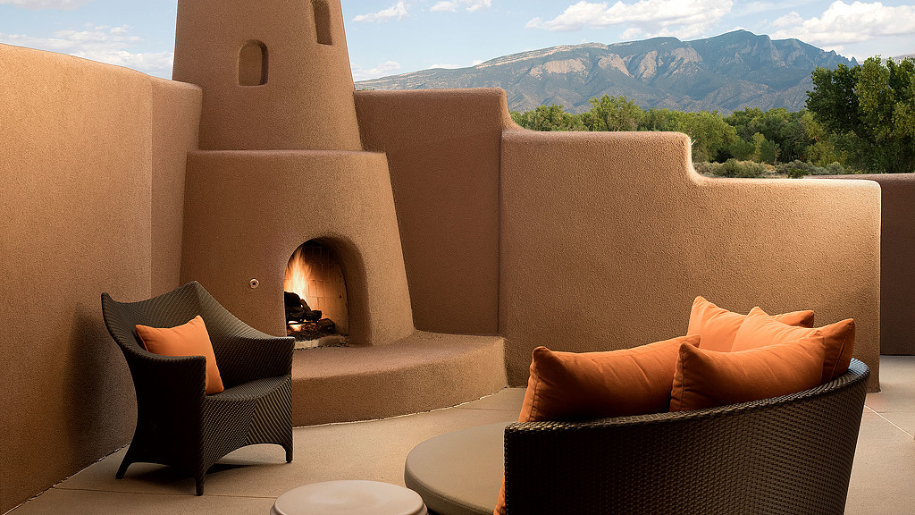 A couch and a chair in a room with a fireplace.
