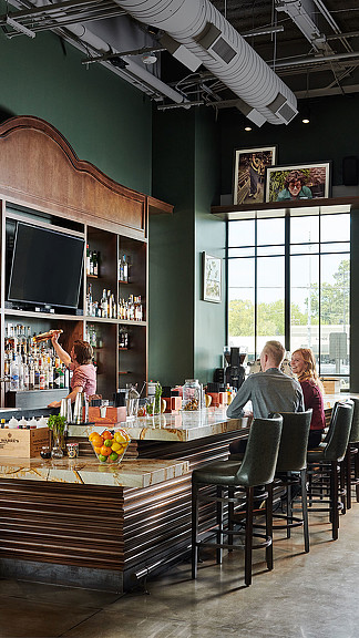 A group of people sitting at a bar.