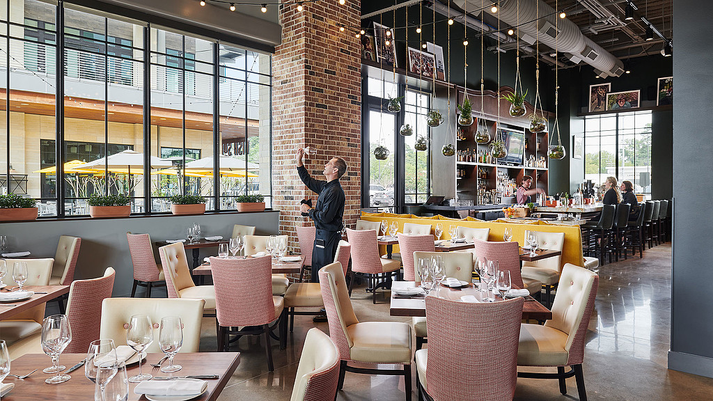 A person standing in a restaurant.