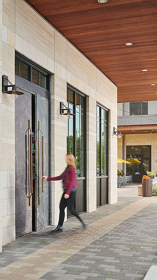 A person walking outside of a building.