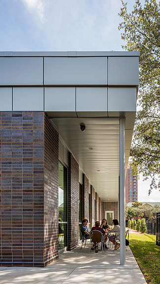 A group of people sitting outside a building.