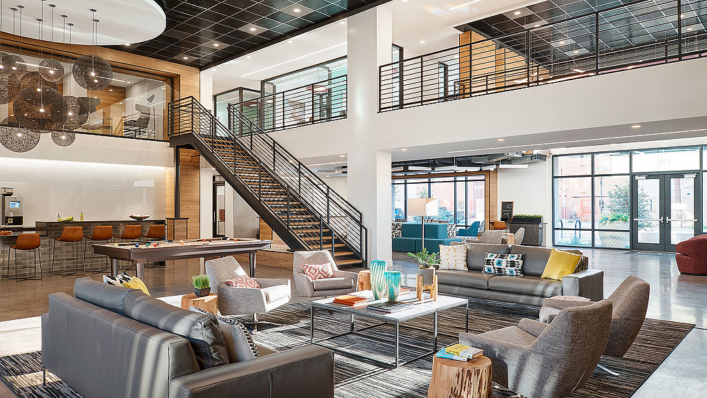 A large living room with a staircase.