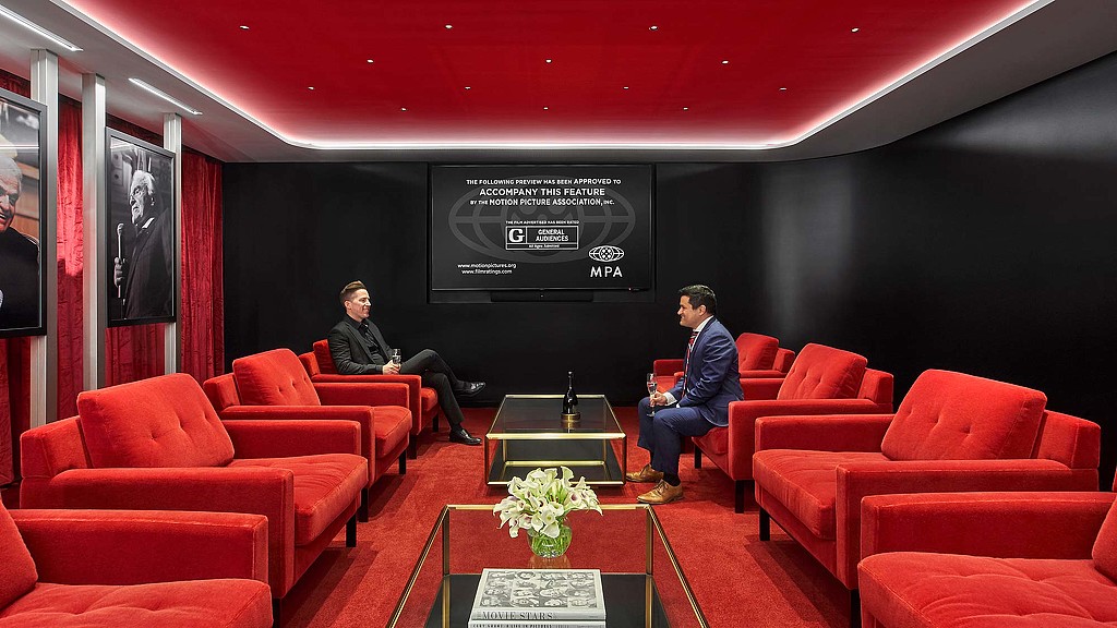 Men sitting in a theater.