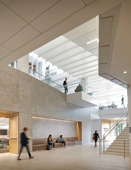 People sitting on benches in a building.