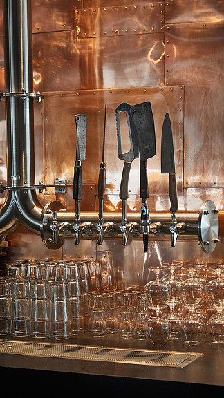 A set of knives on a shelf.