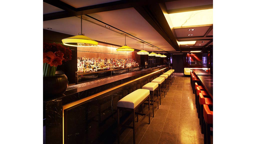 A bar with stools and a counter.