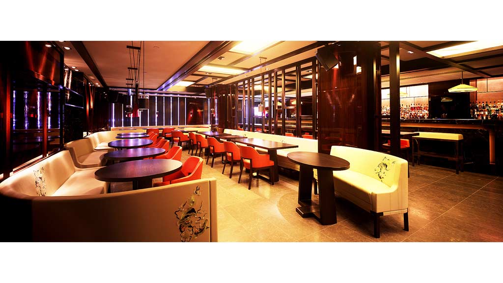 A room with a few couches and tables.