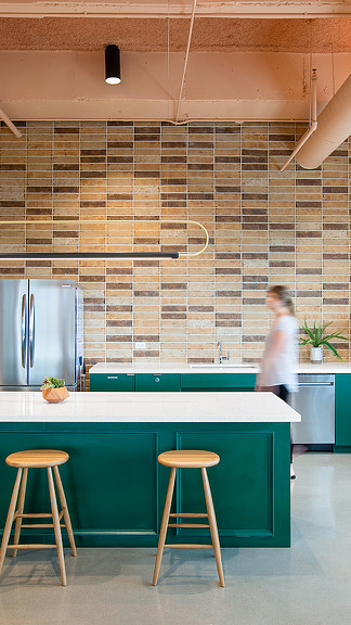 A person standing in a kitchen.