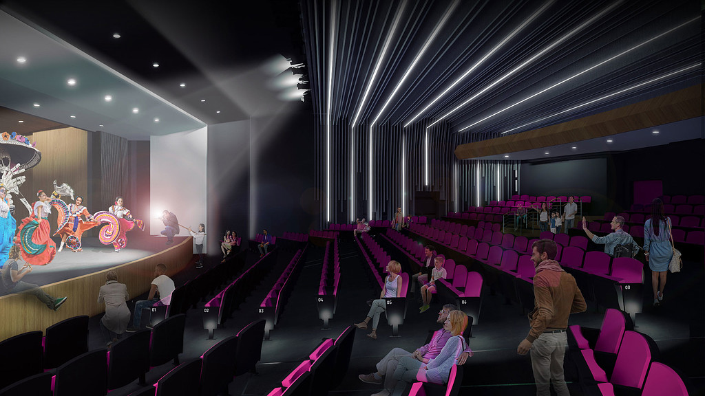 A group of people sitting in a room with purple chairs.