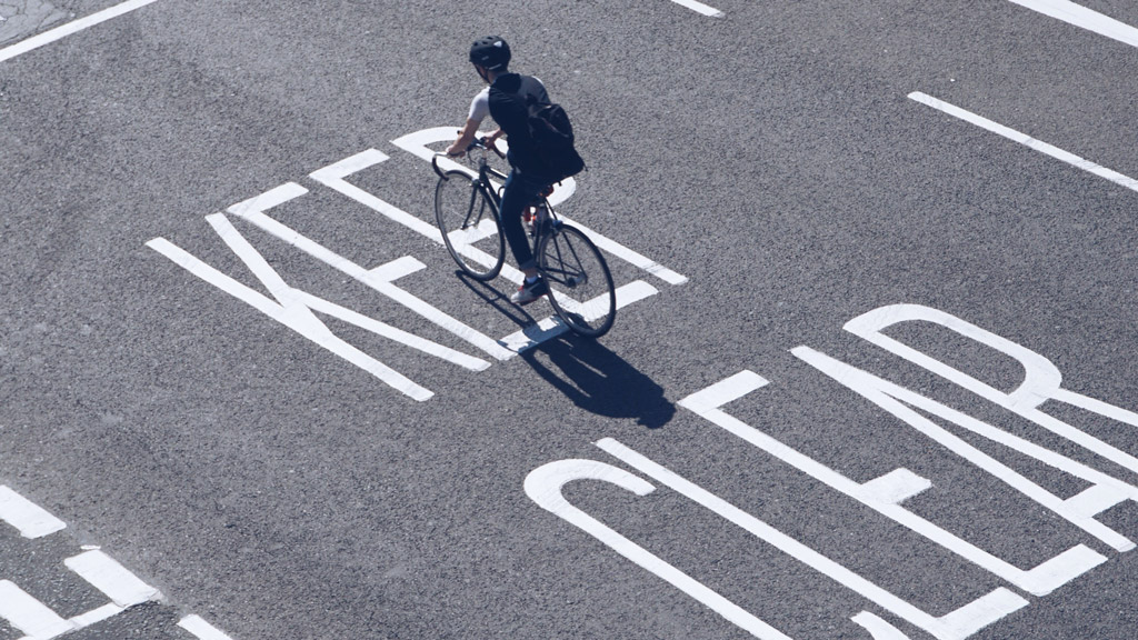 A man riding a bicycle in a crosswalk.