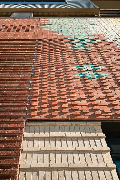 A brick wall with a brick walkway.