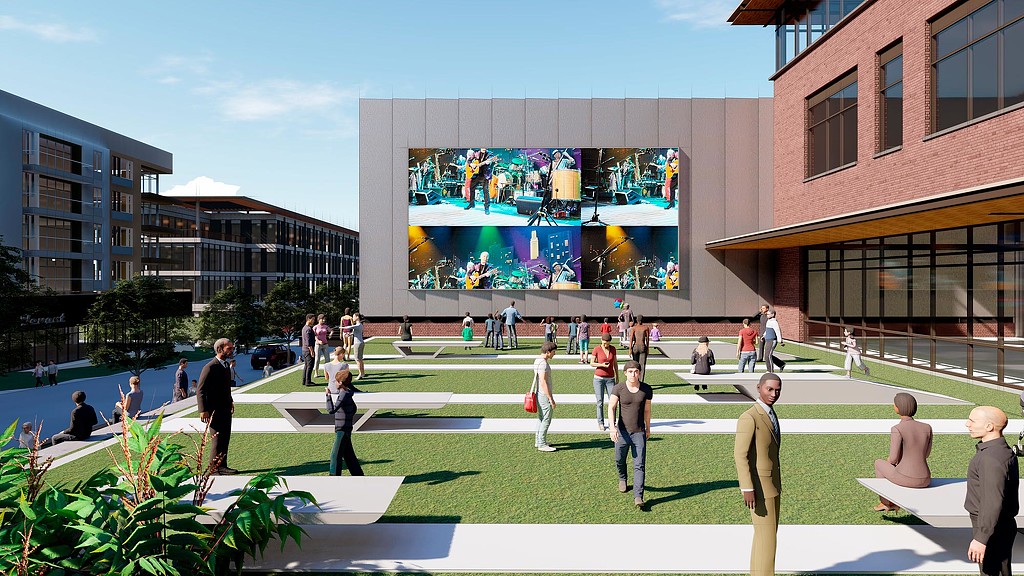 A group of people walking around a large building.