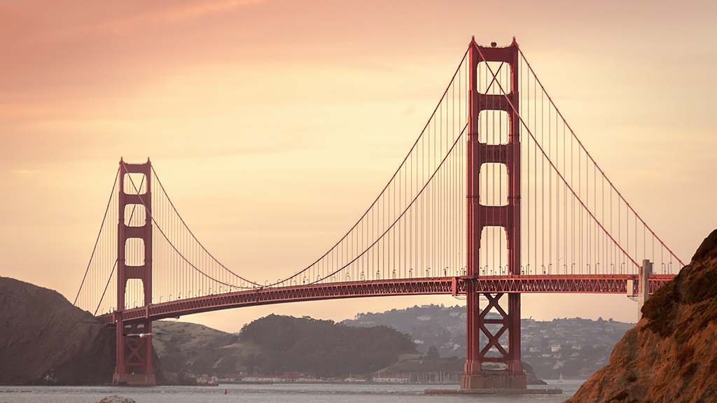 A large red bridge with Golden Gate Bridge in the background.