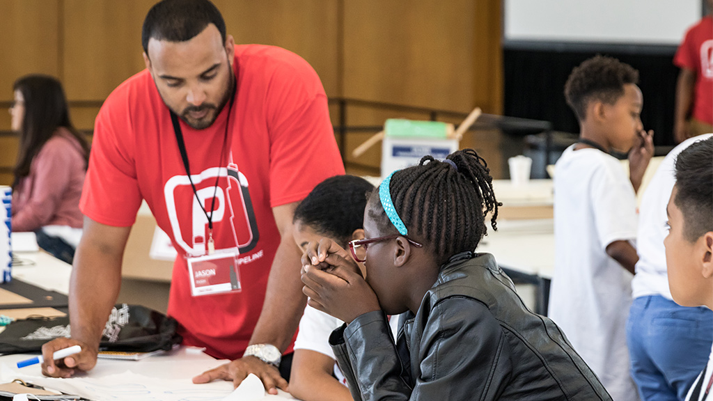 A group of people looking at a paper.
