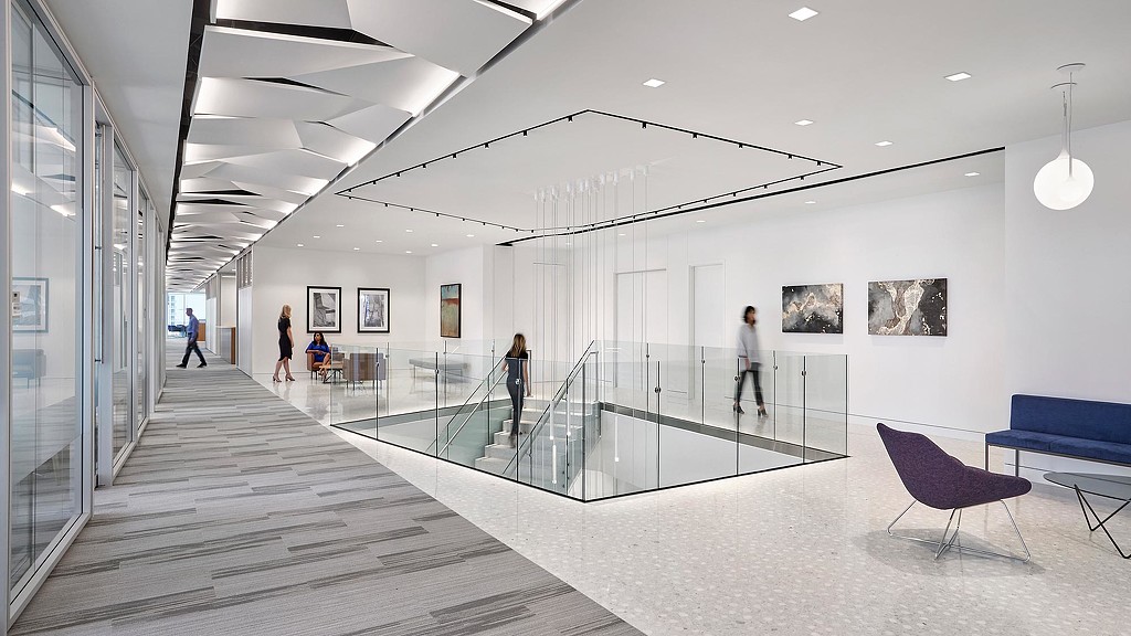 A group of people walking inside a building.