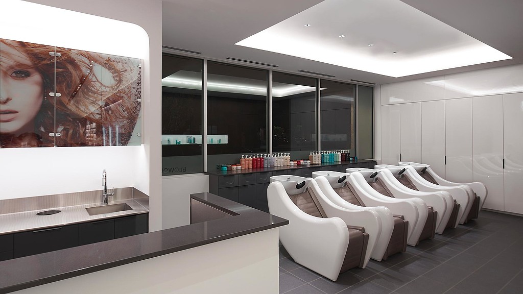 A room with a large screen and chairs.