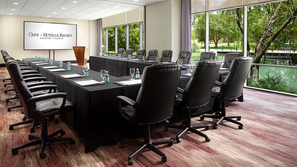 A conference room with a table and chairs.