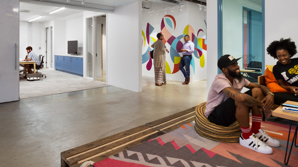 A group of people sitting on the floor.