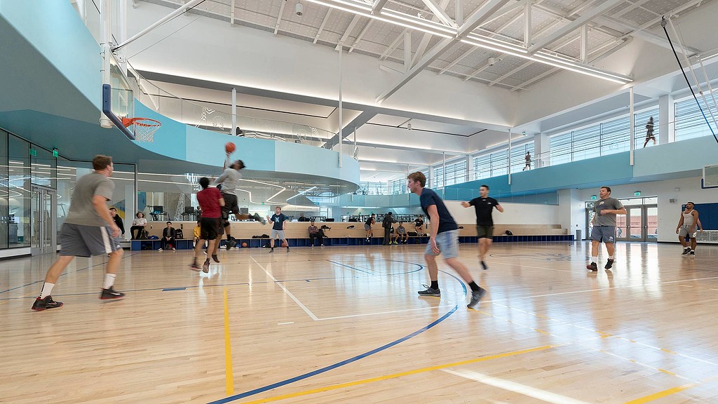 A group of people playing basketball.