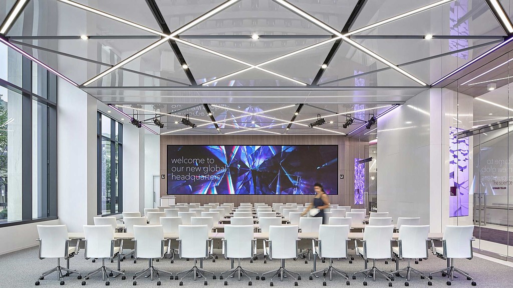 A room with a screen and chairs.