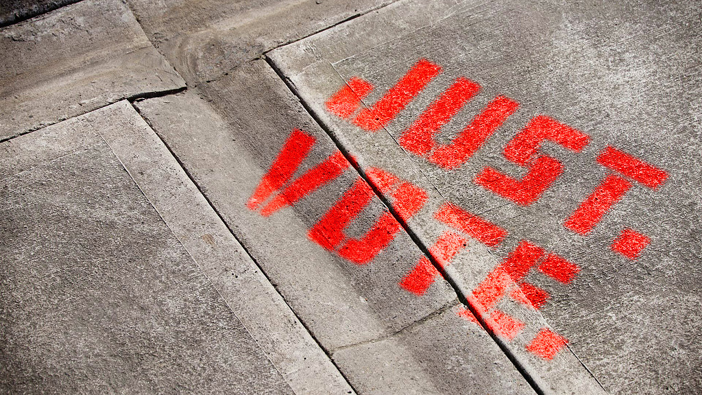 A sidewalk with red writing.
